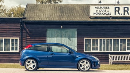 2003 Ford Focus RS in side profile shot with old-school garage backdrop