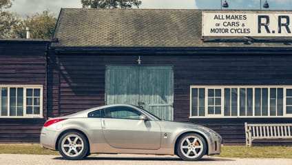 350Z in side profile shot with old-school garage backdrop