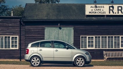 Audi A2 in side profile shot with old-school garage backdrop