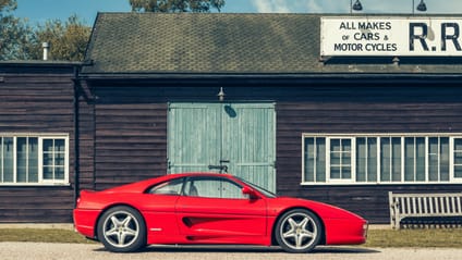 1994 Ferrari F355 in side profile shot with old-school garage backdrop