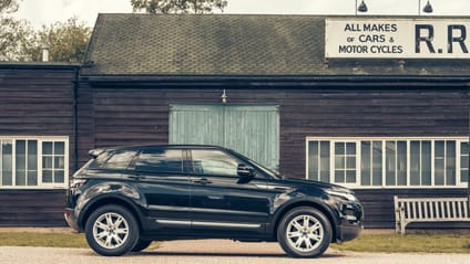 Evoque in side profile shot with old-school garage backdrop