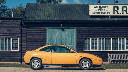 1993 Fiat Coupe with old school garage backdrop, in side profile shot