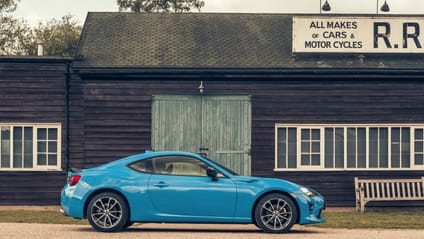 GT86 in side profile shot with old-school garage backdrop