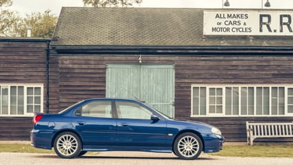 2001 Ford Mondeo with old school garage backdrop, in side profile shot