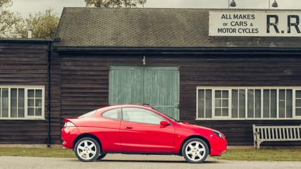 1997 Ford Puma in side profile shot with old-school garage backdrop