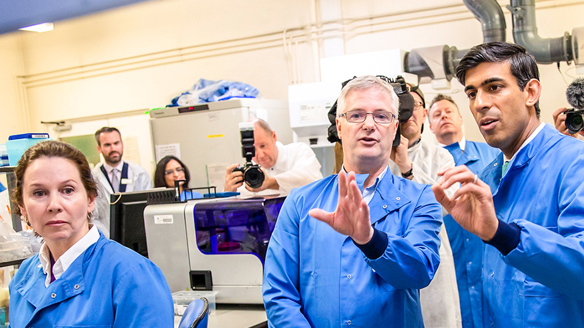 Rishi Sunak in a lab coat with chemists