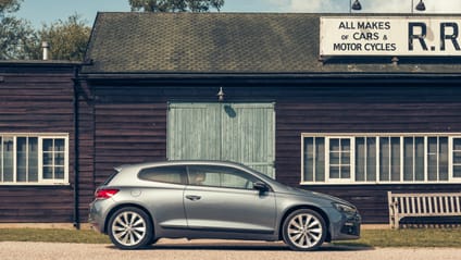 Scirocco in side profile shot with old-school garage backdrop