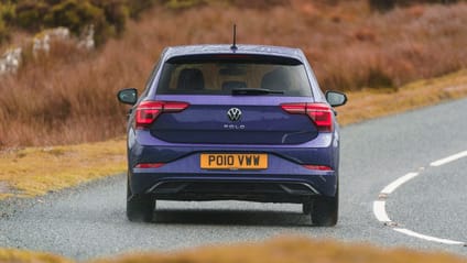 Rear driving shot of VW Polo on country road