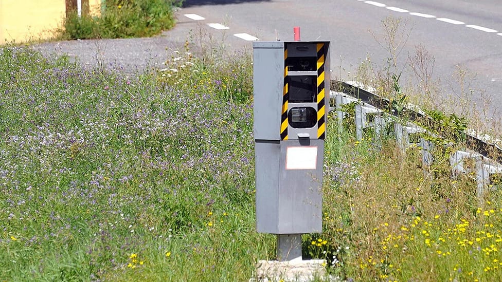 Road traffic speeding camera pictured on grass verge