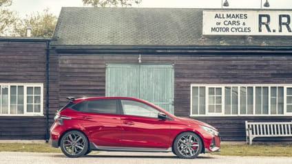 i20N in side profile shot with old-school garage backdrop