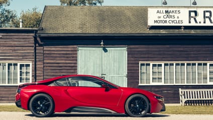 i8 in side profile shot with old-school garage backdrop