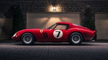 This Ferrari 250 GTO is sitting in front of a triple garage with an old-fashioned lamp light spotlighting the car