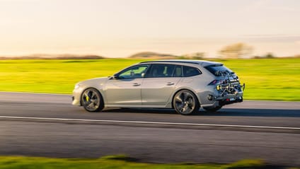 Driving shot in side profile of Peugeot 508 PSE SW hybrid