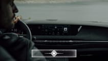 Man behind the wheel of a DS4 with the Iris voice control prompt box superimposed over the image