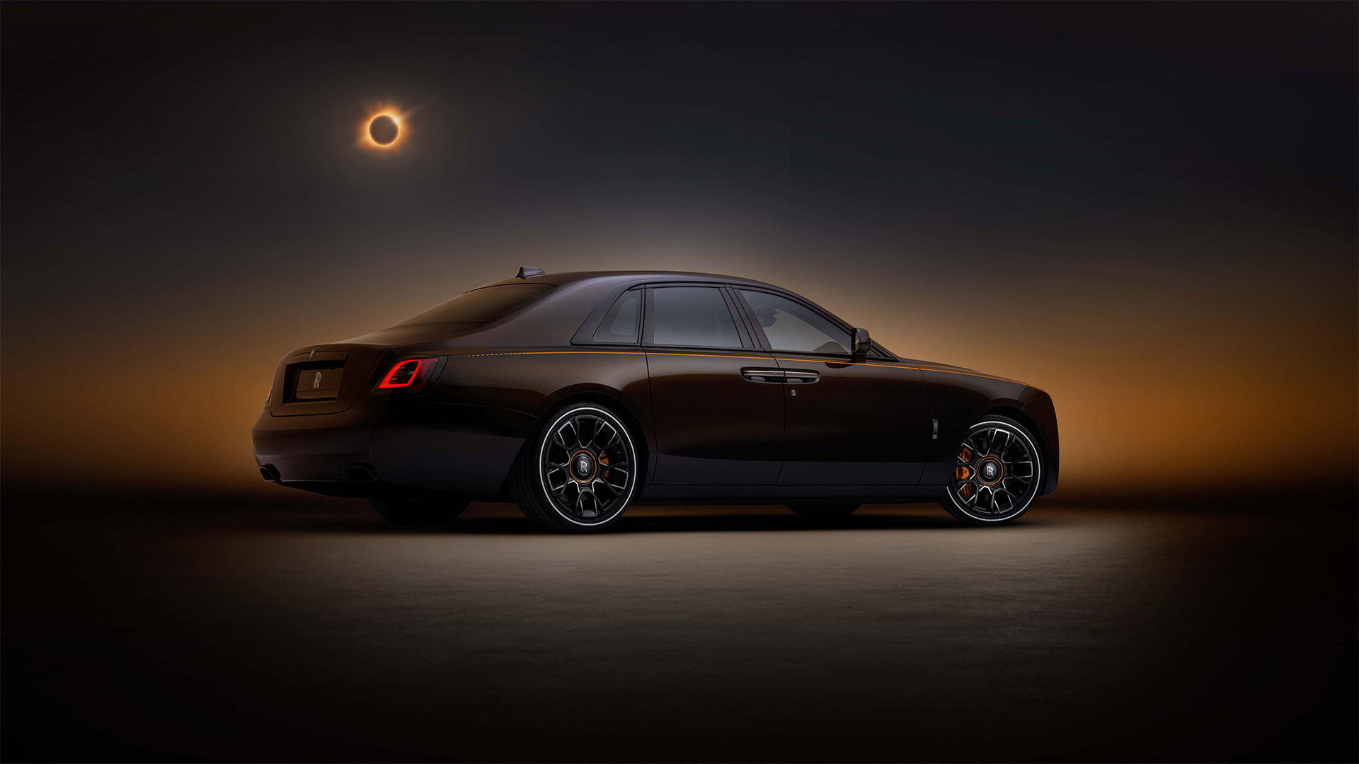 Static studio shot of Rolls-Royce Black Badge Ghost Ekleipsis, from rear