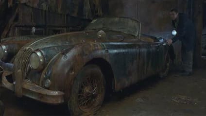 Scene from 2002 movie Ghost Ship where Jaguar XK150 Roadster (main subject) is rusted with bullet holes