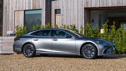 Static shot in front of wooden building of Lexus LS 500h