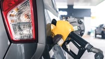 Close up of petrol pump in a fuel tank of a silver car