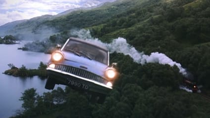 Shot of flying 1962 Ford Anglia from movie Harry Potter and the Chamber of Secrets (2002), with steam coming from train below