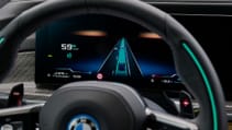 Close up of instrument cluster through steering wheel showing BMW 7 Series in autonomous mode