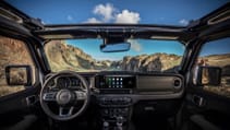 Interior shot of the 2024 Jeep Wrangler 4xe on beach taken from rear seats looking out of windscreen