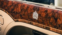 Close up of royal crest on burr walnut dash in Bentley Mulsanne, last one produced and commissioned by Queen Elizabeth II