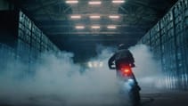 Rider creating tyre smoke by donuting Verge TS Pro in beast mode in a warehouse