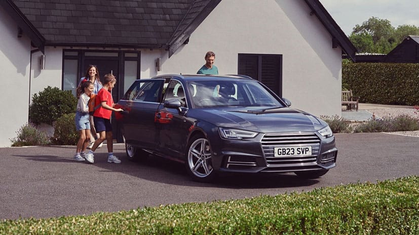 A family of four getting into a car