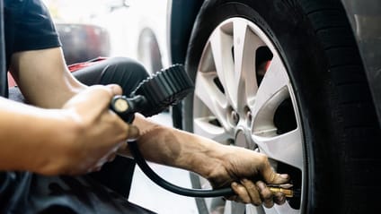 Someone checking tyre pressure