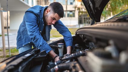 A mechanic inspecting a car