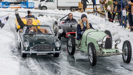 Four electric cars from The Little Car Company coming to the finish line in snow