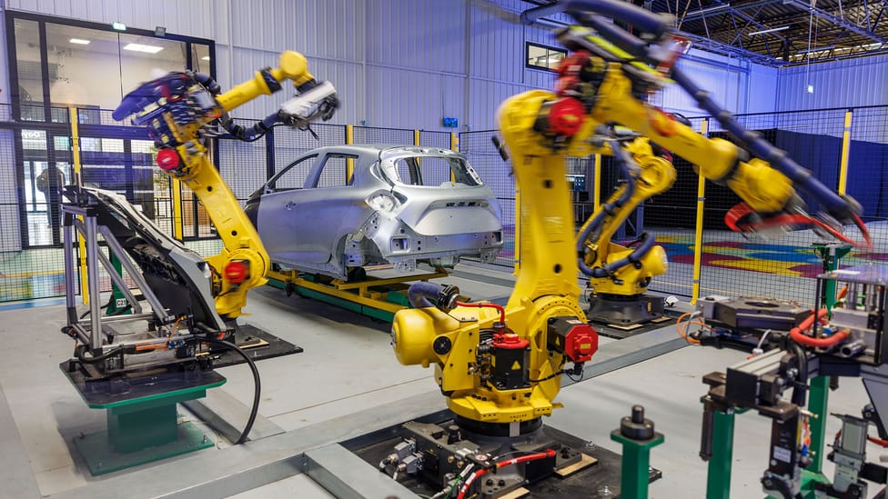 Renault Zoe chassis on display with robotic machines poised, denoting Renault's Industrial Metaverse day