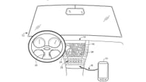 A black and white patent illustration of a driver cockpit with maps and buttons in the centre console, annotated with numbers and arrows