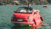 Car 500 Off-Shore in red with man steering standing as he heads to dock