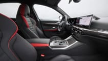 2024 BMW i4 refresh - interior with grey cloth seats accented with red, shot from passenger side looking at drivers side