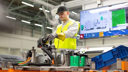 Technician works to put battery pack components together for e-Power unit, using OSG