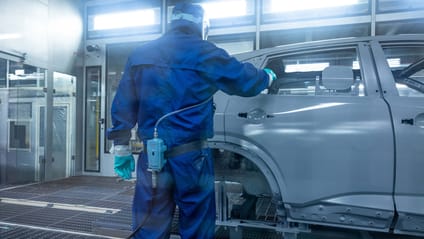 Technician in paint shop checks body shell