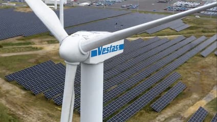 Sky view of Nissan plant solar farm with wind turbine in foregroud