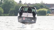 The Candela C-8 DC on water with hydrofoils deployed, shot from rear