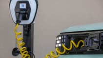 Close-up shot of Fiat Grande Panda, connected to EVSE on integrated charging cable