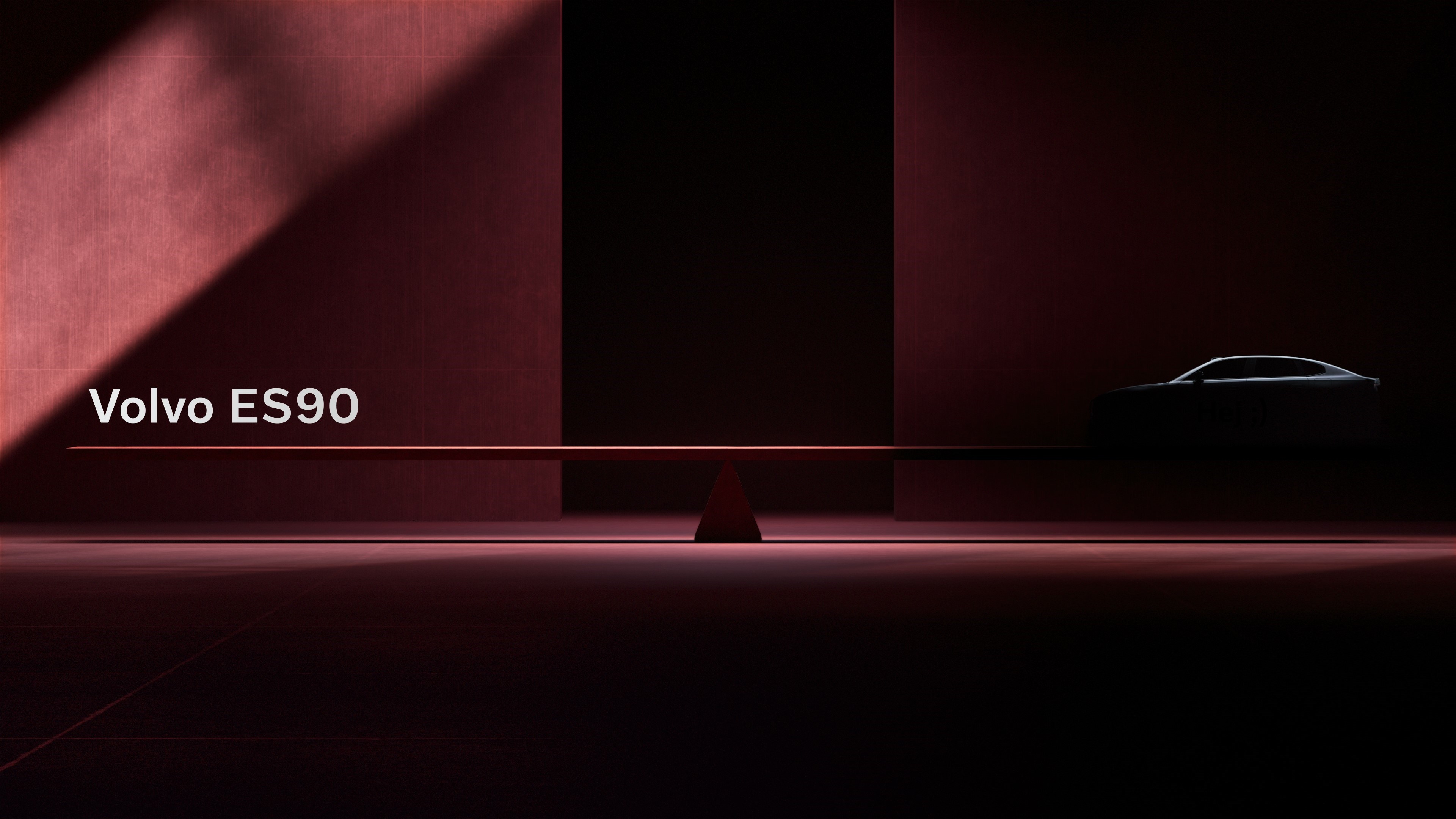 Volvo ES90 teaser shot in shadows with car balanced on scales