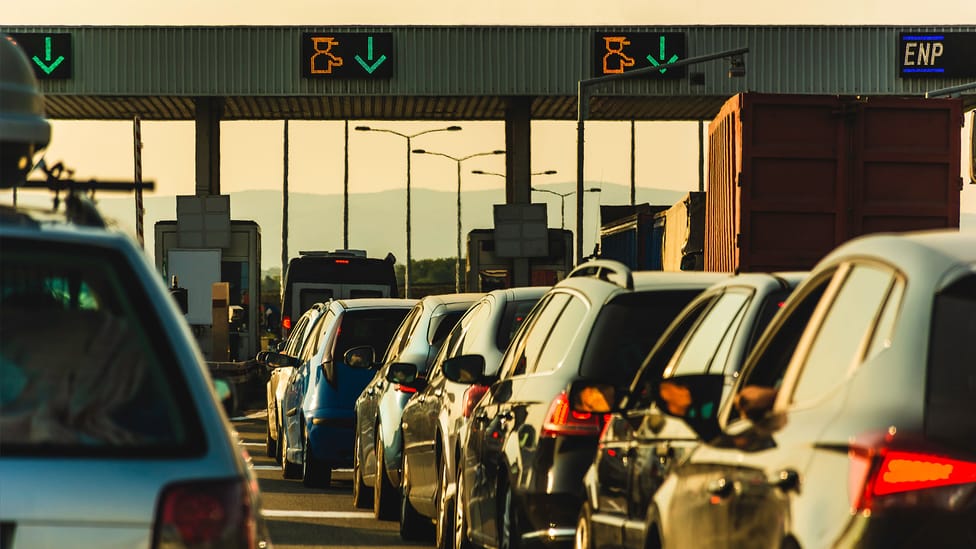 Shot of cars waiting in a queue for a toll road