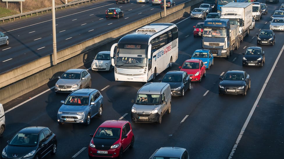 Congestion on the motorway, various cars and buses queuing