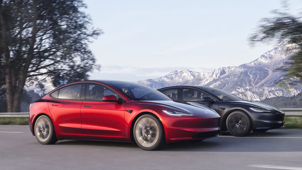 Tesla Model 3 long range driving shot of two cars alongside one another