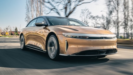 Lucid Air - driving shot with sunny sky and trees in background