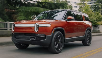 Rivian R1S - driving shot with leafy background