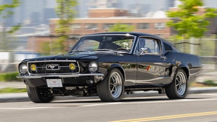 A driving shot of the Velocity Mustang in black