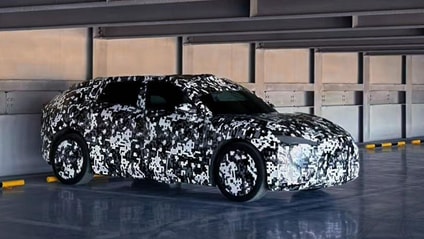 Faraday Future's FX prototype model in camo wrap parked in a garage