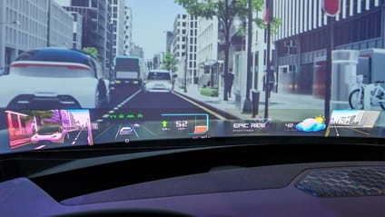 Hyundai Mobis holographic windscreen technology shows various graphics on windscreen while car is driving down simulated street