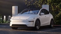 The 2025 Tesla Model Y Juniper parked and connected at a Tesla Supercharger